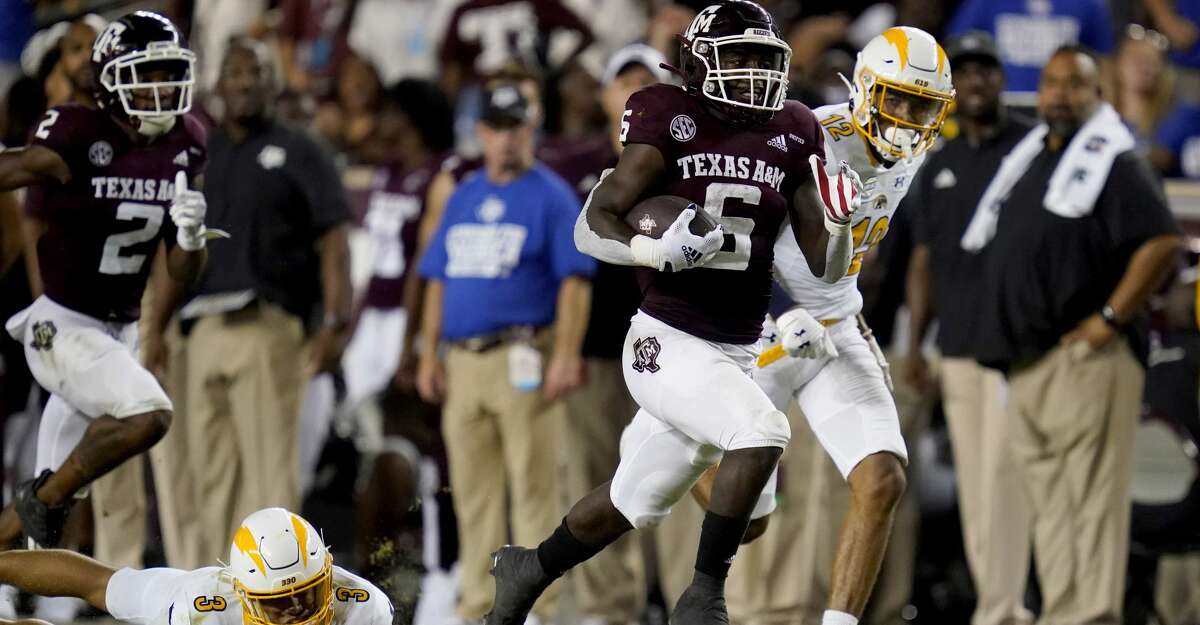 Texas A&M running back Devon Achane (6) escapes a tackle by Kent State safety Dean Clark (3) as he races for a touchdown during the second half of an NCAA college football game on Saturday, Sept. 4, 2021, in College Station, Texas. (AP Photo/Sam Craft)