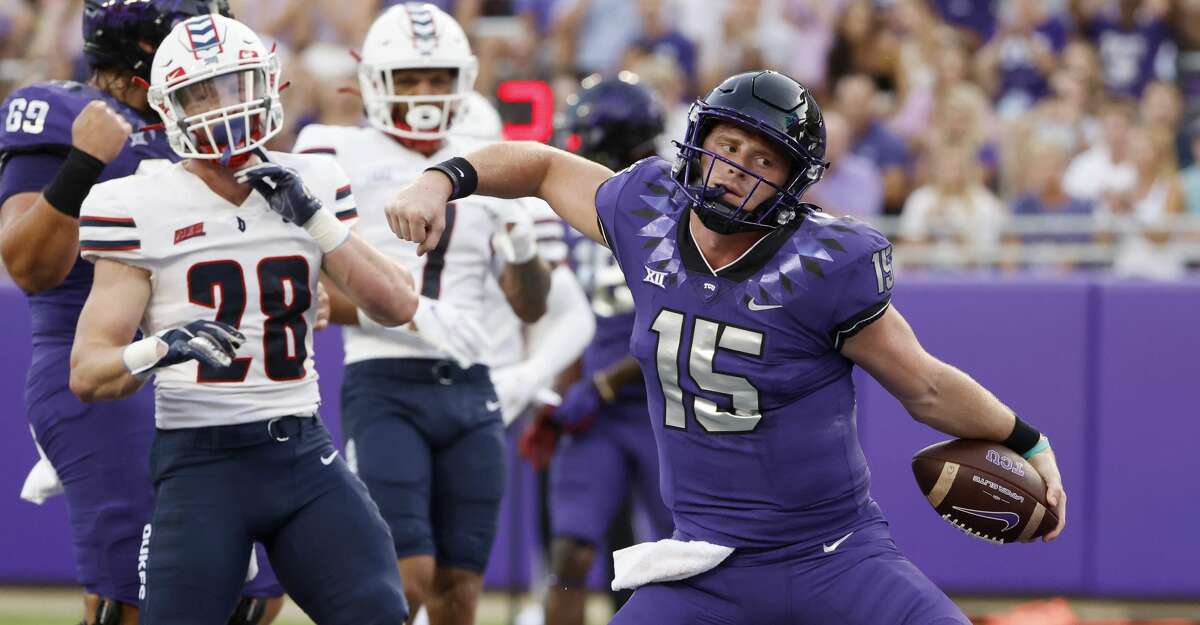 TCU quarterback Max Duggan (15) reacts after running the ball in for a touchdown as Duquesne defensive backs Spencer DeMedal (28) and Leandro Debrito (7) look on during the first half of an NCAA college football game Saturday, Sept. 4, 2021, in Fort Worth, Texas. (AP Photo/Ron Jenkins)