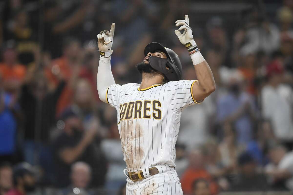 SAN DIEGO, CA - SEPTEMBER 4: Fernando Tatis Jr. #23 of the San Diego Padres points skyward after hitting a two-run home run during the eighth inning of a baseball game against the Houston Astros at Petco Park on September 4, 2021 in San Diego, California. (Photo by Denis Poroy/Getty Images)
