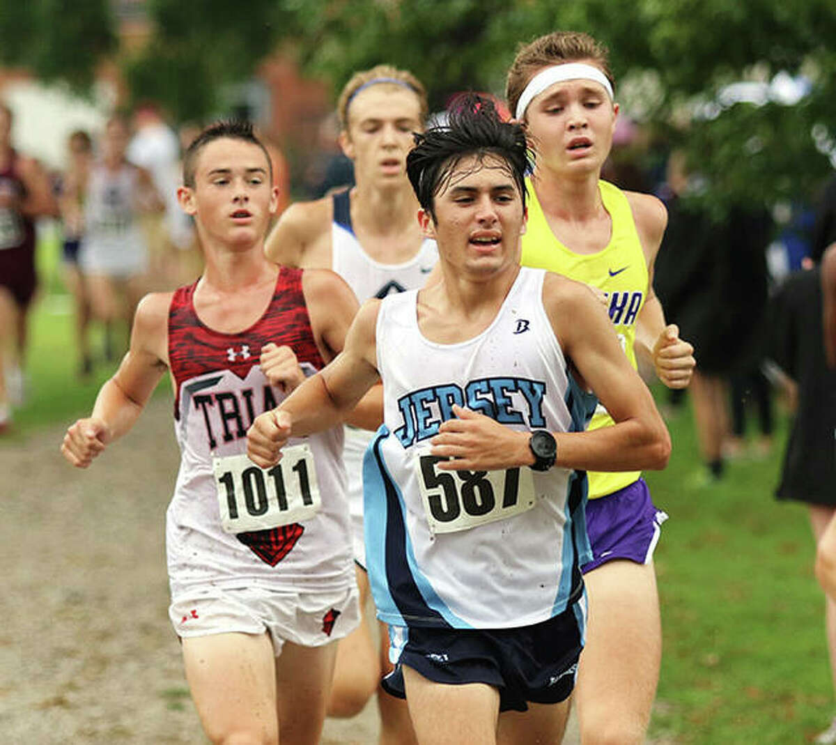 Jersey senior Cole Martinez (front) leads Triad sophomore Andrew Pace (1011) and Eureka senior Jake Brueggemann in the final 400 meters at Saturday morning’s Granite City Invite at Wilson Park. Martinez ran 16th in the race, with Pace in 14th and Brueggemann in 17th.