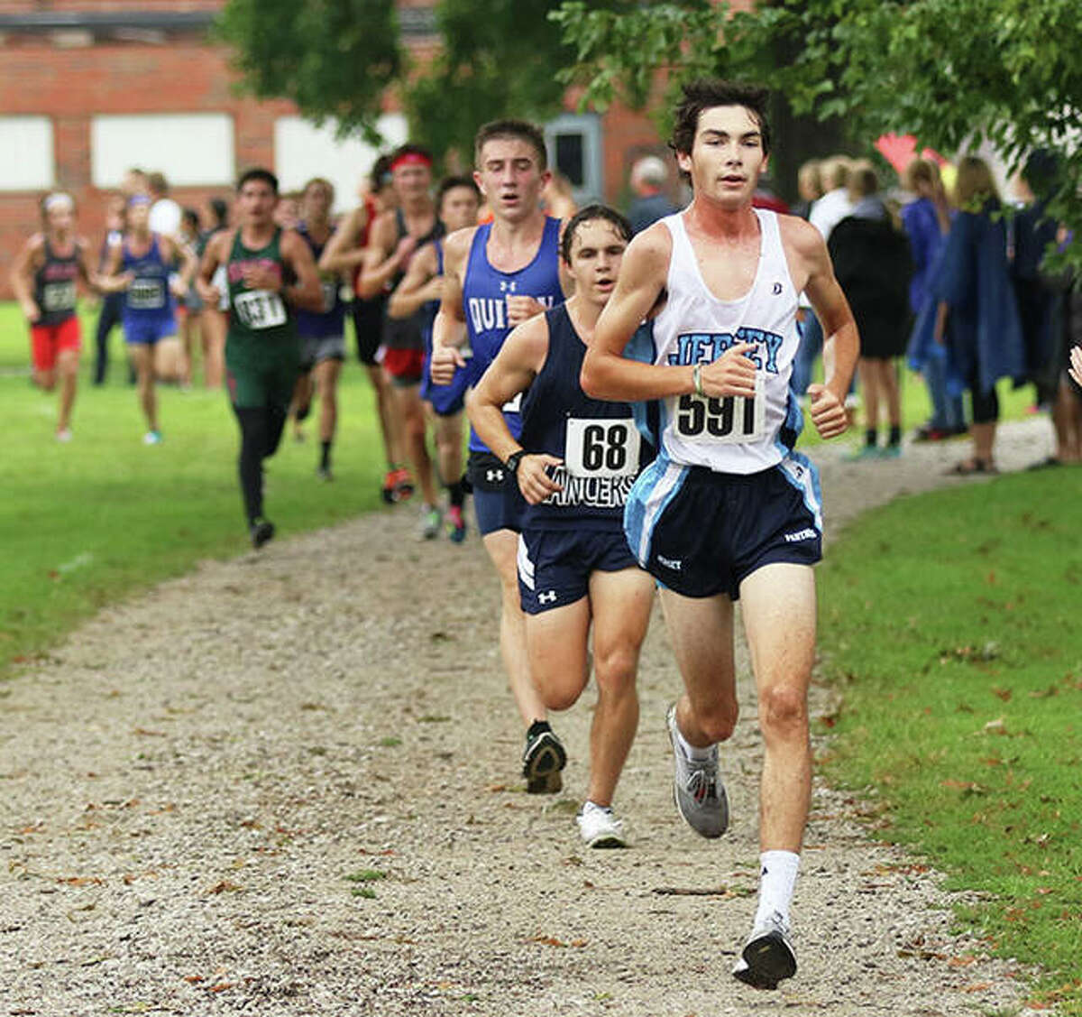 Jersey junior Griffin Williams (front) leads a line of runners in the final quarter-mile of the Granite City Invite on Saturday.
