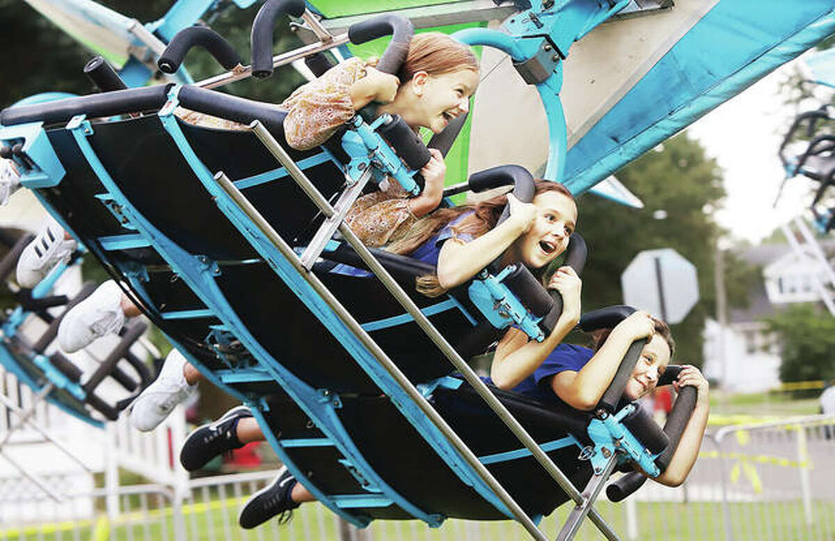Arabelle Marburger, 9, left, her sister, Ahnalle Marburger, 11, center, both from Godfrey, and their friend, Averi Lowe, 10, from Bethalto, seemed to be enjoying their time on the Hang Glider ride at the Bethalto Homecoming over the weekend. Hundreds packed the midway Friday for opening night of the homecoming. The event runs through Monday. More photos appear online at thetelegraph.com.