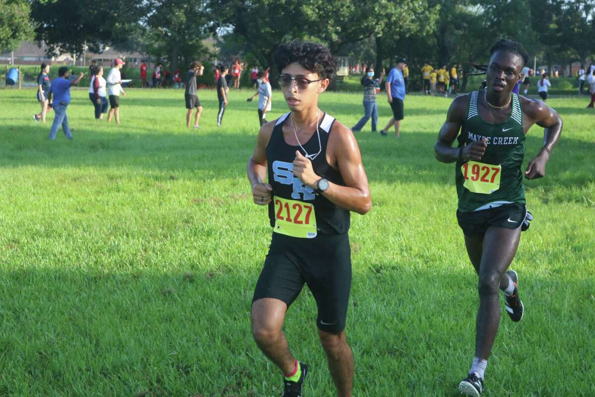 Sam Rayburn's Jonathan Rivera, en route to winning the boys' medalist crown, feels some pressure from a Mayde Creek runner. Rivera was clocked in 15:50.54.