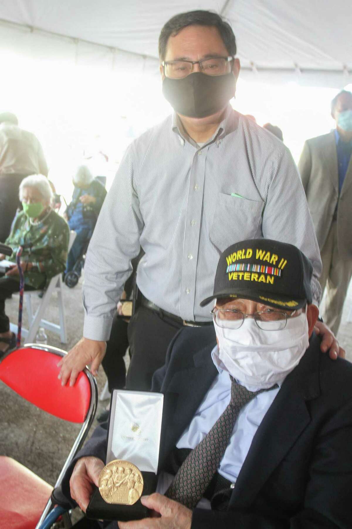 Andrew Yee, left, with his father, Paul Yee, who is holding his medal as the Chinese American Citizens Alliance (C.A.C.A.) Southern Region Congressional Gold Medal Committee hosted the Congressional Gold Medal Ceremony for four living Chinese American WWII veterans, surviving widows, and other next of kin of the service members.