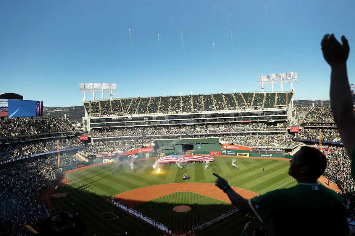 Fans cheer a flyover during National Anthem before Oakland Athletics play Tampa Bay Rays in American League Wild Card game at Oakland Coliseum in Oakland, Calif., on Wednesday, October 2, 2019.
