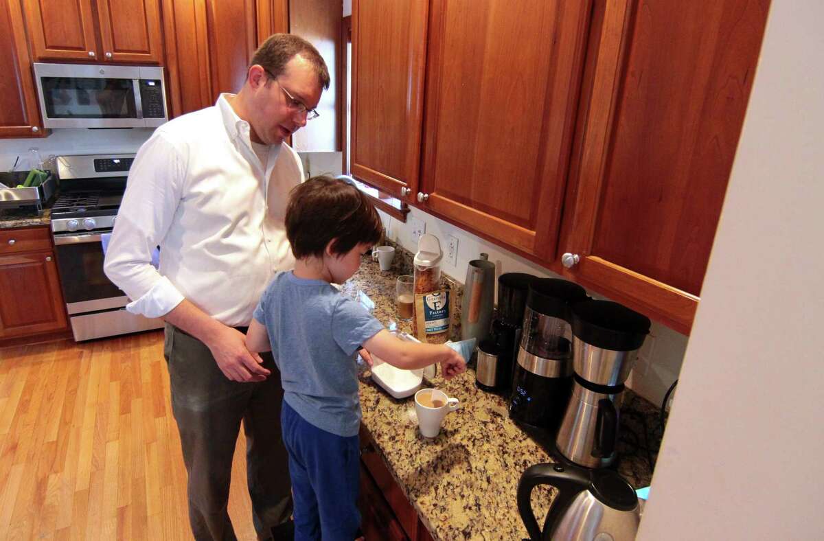 Matthew Lee, 3, helps his dad Ben make coffee together at his home in Stamford, Conn., on Saturday Sentember 4, 2021. Lee, who is a City Rep., D-15, also served in the U.S. Army and worked closely with a translator while in Afghanistan. He recently helped the translator's family flee the country on one of the last military flights out.