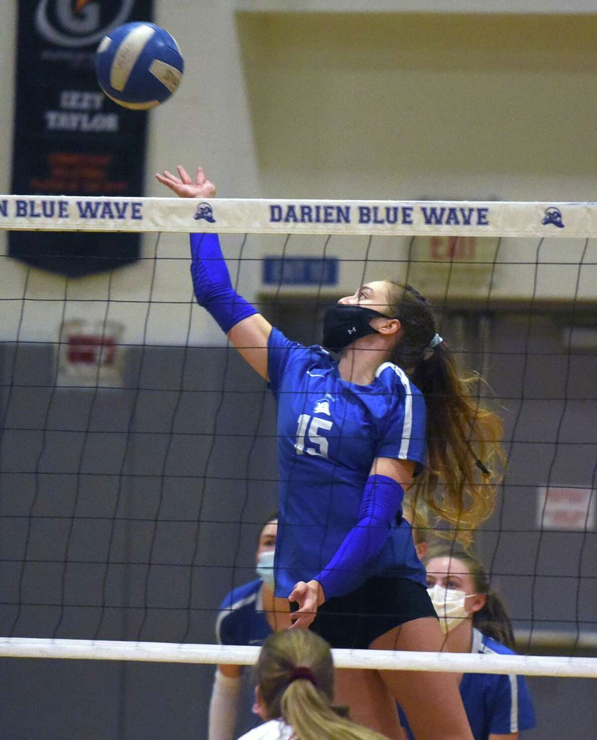 Darien's Leilani Gillespie (15) goes up for a shot during the Blue Wave's girls volleyball match against Greenwich in Darien on Thursday, Oct. 29, 2020.