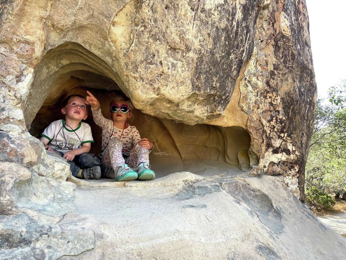The author's kids find a hideout during a recent visit to Rock City.