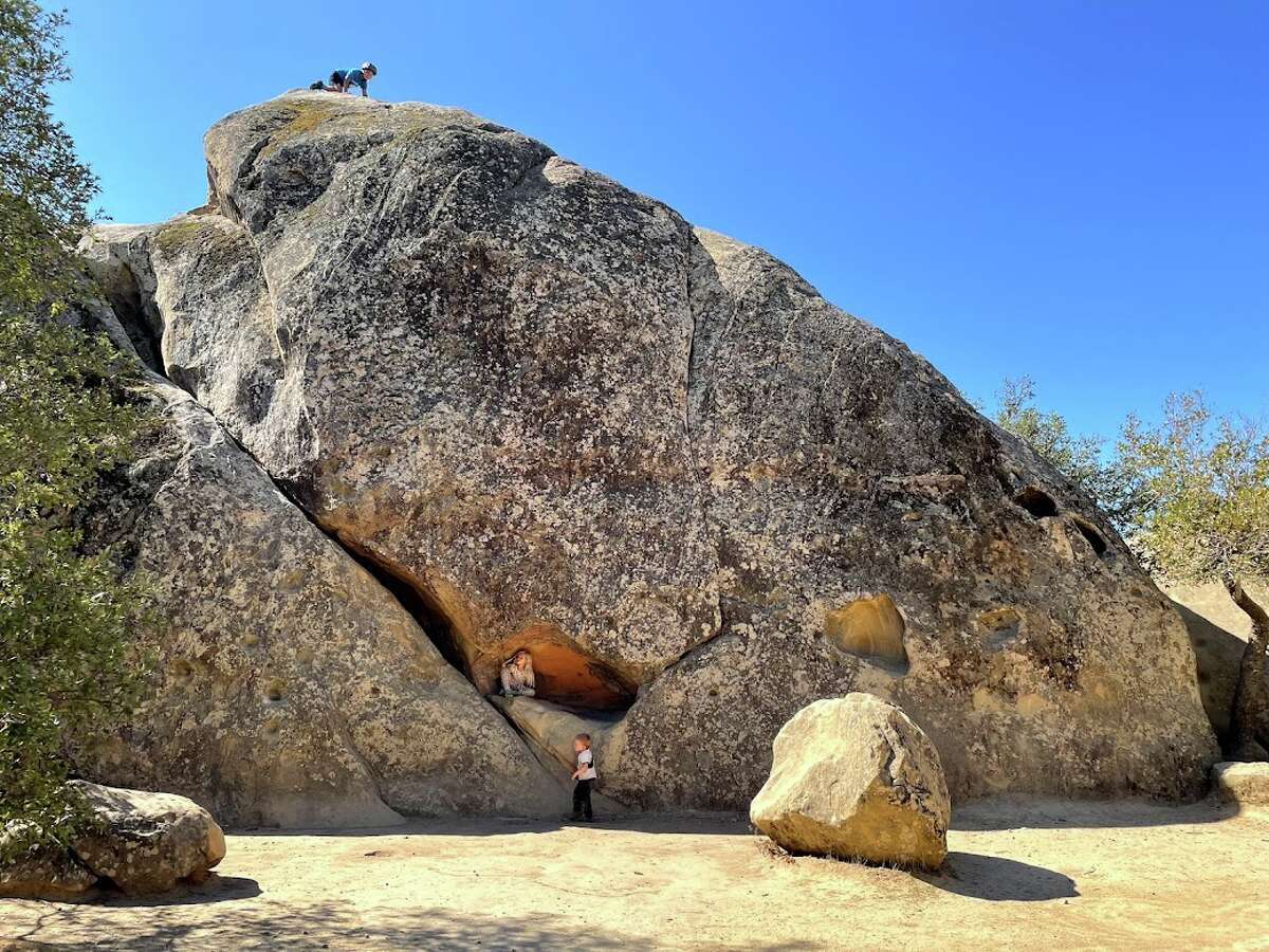 Kids climbing a multi-story boulder at Rock City at Mount Diablo State Park.