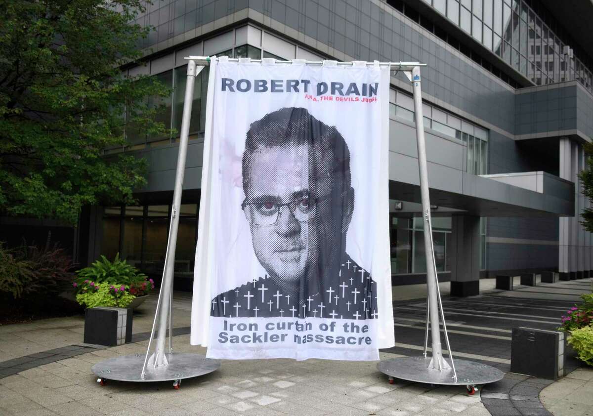 A curtain depicting Judge Robert Drain, who is presiding over Purdue Pharma’s bankruptcy case, is displayed outside Purdue’s headquarters at 201 Tresser Blvd in downtown Stamford, Conn., on Wednesday, Sept. 1, 2021.