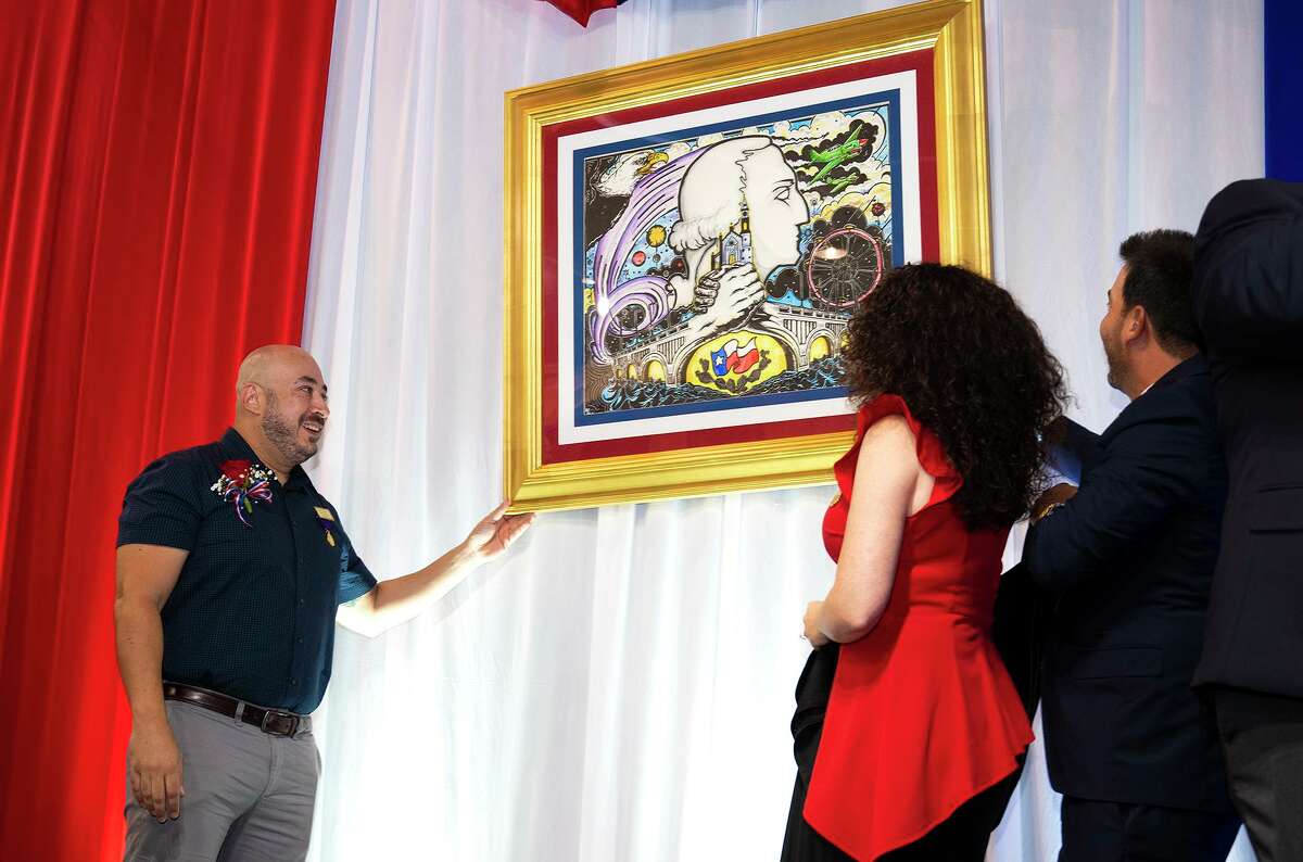 Poster artist Rene Gutierrez admires his art piece after unveiling it to the public a year after its completion, Friday, Sept. 3, 2021, at the Laredo Center for the Arts during the WBCA's 124th Celebration Poster Unveiling.