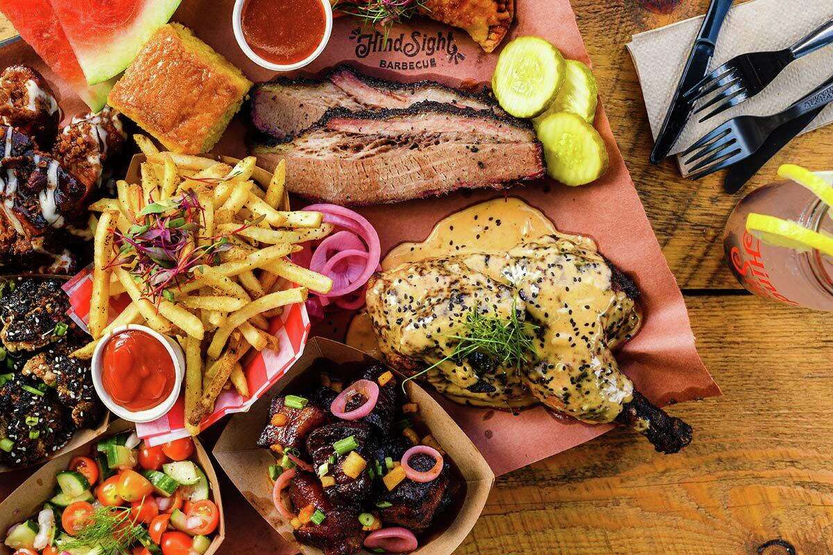 An assorted meat platter with burnt ends and ribs and pickles, watermelon and pickled onions from Hindsight BBQ in Waterbury, Conn.