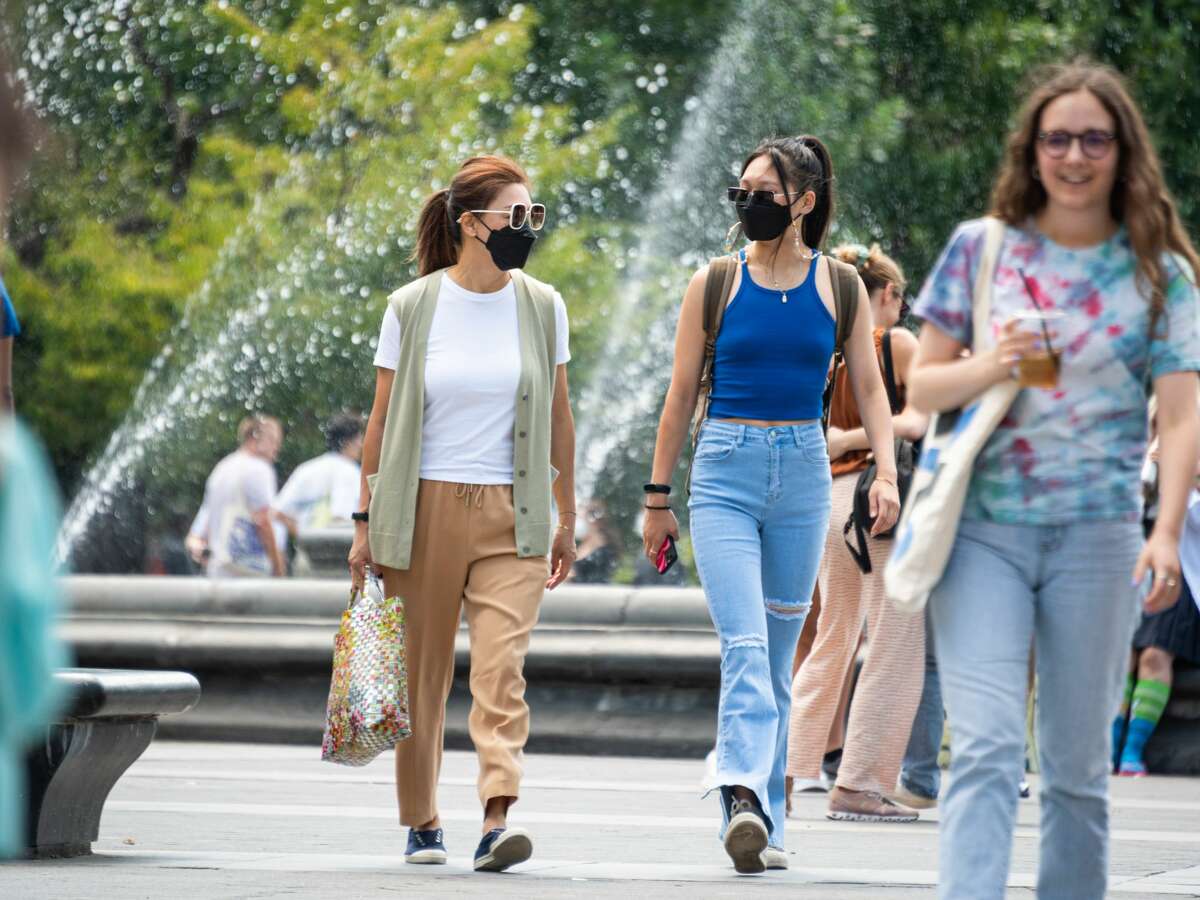 People wear face masks in Washington Square Park over Labor Day Weekend on September 06, 2021 in New York City. (Photo by Noam Galai/Getty Images)