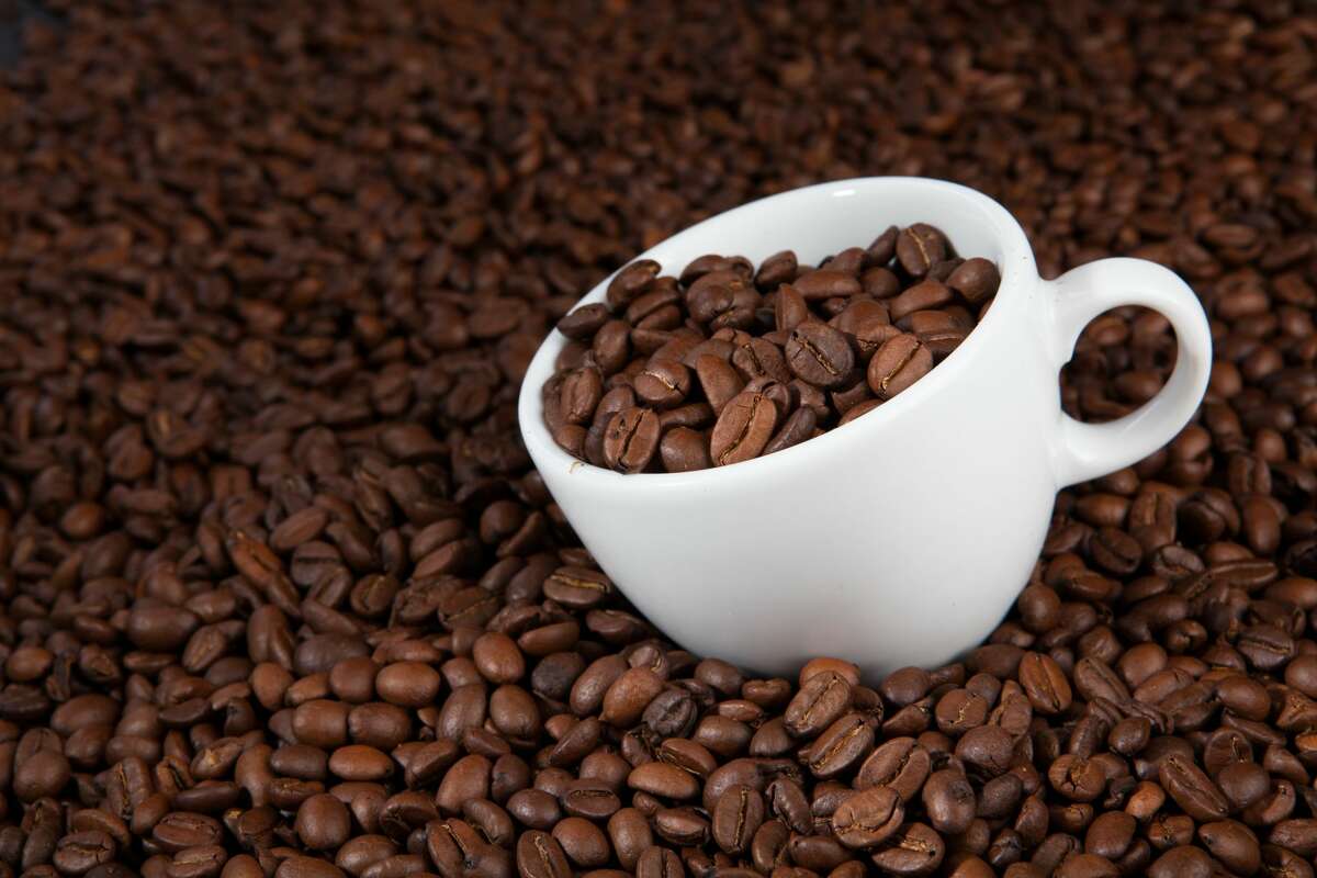 FILE—A mug full of coffee beans.