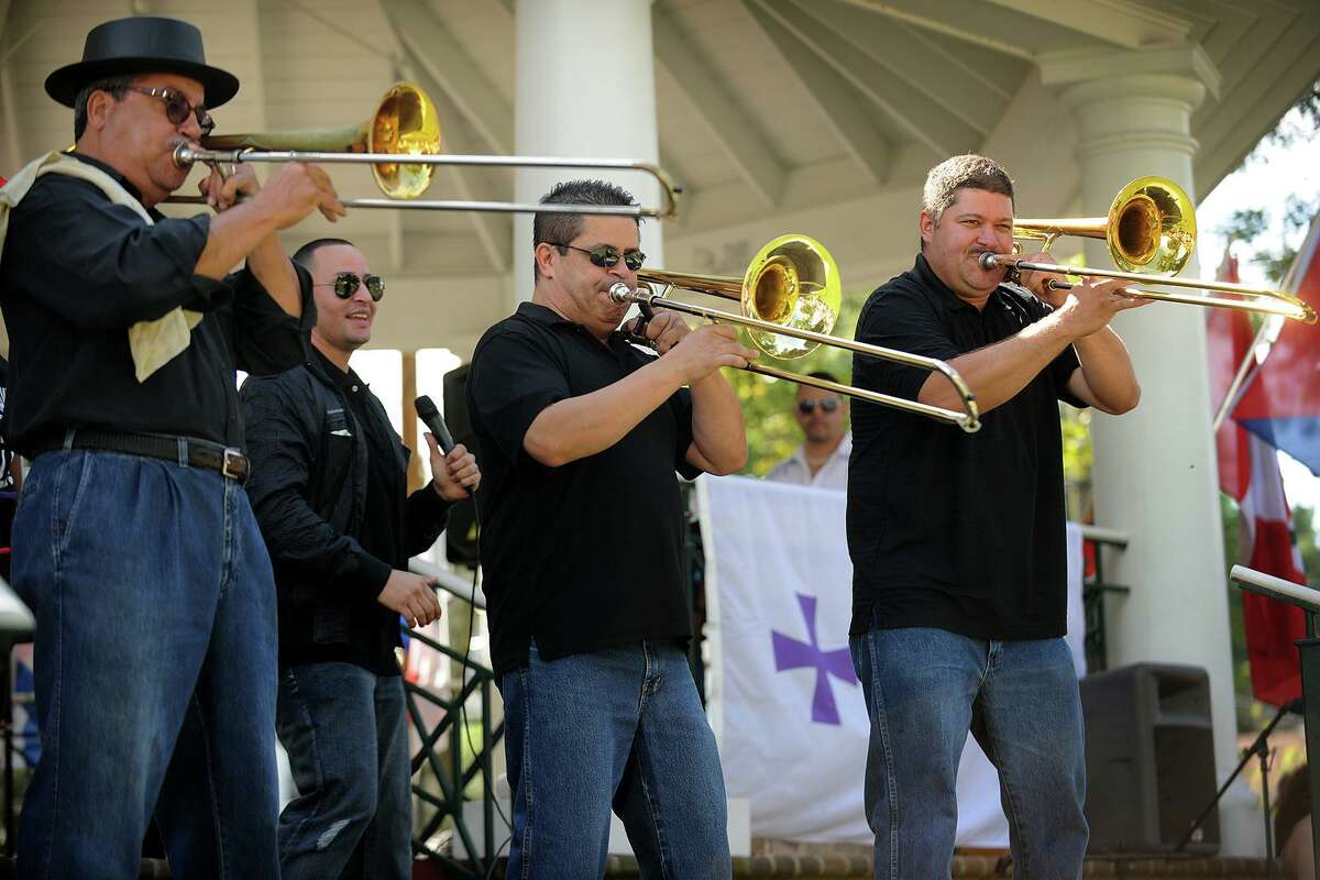 A trio of trombones take center stage during the Bridgeport-based salsa band Afinke's performance at the first annual Stratford Latin Music Festival on Paradise Green in Stratford, Conn. on Sunday, September 15, 2013.