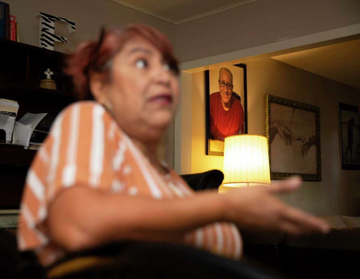 A photograph of Albert Ramirez hangs on the wall as Esmeralda Trigo talks about her brother, who died in June in the custody of the Fort Bend County sheriff's office, Tuesday, Aug. 24, 2021, at her home in Rosenberg. Ramirez had been jailed for 16 months on an aggravated robbery charge when he died. Preliminary autopsy results show he died from natural causes, including cirrhosis of the liver. However, his family has hired a lawyer and is questioning whether he received the right medical care.
