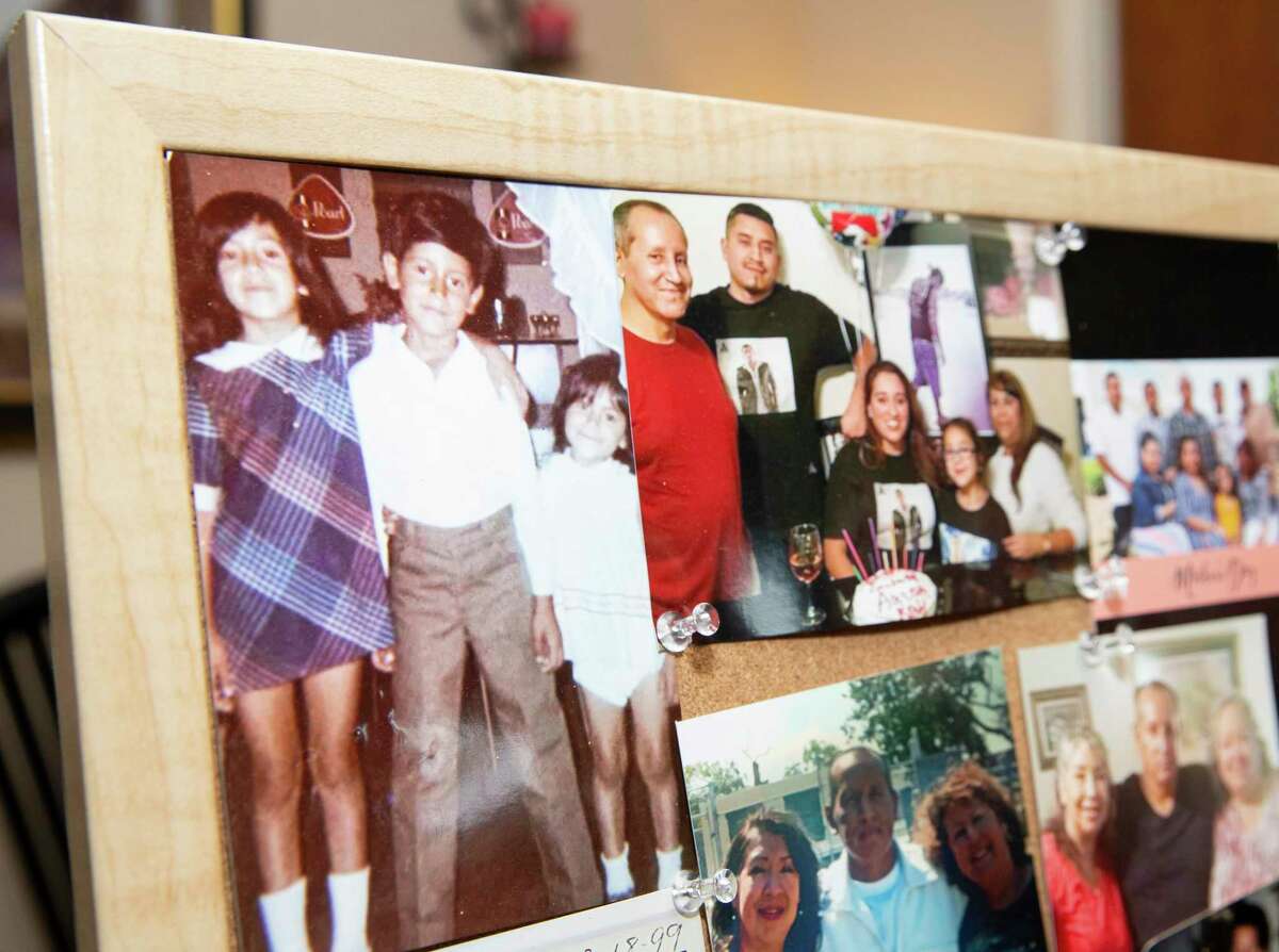 Esmeralda Trigo shows a collage of family photos of her brother, Albert Ramirez, who died in June in the custody of the Fort Bend County sheriff's office, Tuesday, Aug. 24, 2021, at her home in Rosenberg. Ramirez had been jailed for 16 months on an aggravated robbery charge when he died. Preliminary autopsy results show he died from natural causes, including cirrhosis of the liver. However, his family has hired a lawyer and is questioning whether he received the right medical care.