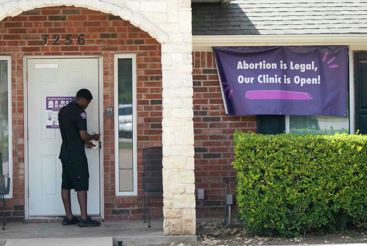 A security guard opens the door to the Whole Women's Health Clinic in Fort Worth, Texas, Wednesday, Sept. 1, 2021. A Texas law banning most abortions in the state took effect at midnight, but the Supreme Court has yet to act on an emergency appeal to put the law on hold. If allowed to remain in force, the law would be the most dramatic restriction on abortion rights in the United States since the high court's landmark Roe v. Wade decision legalized abortion across the country in 1973. (AP Photo/LM Otero)