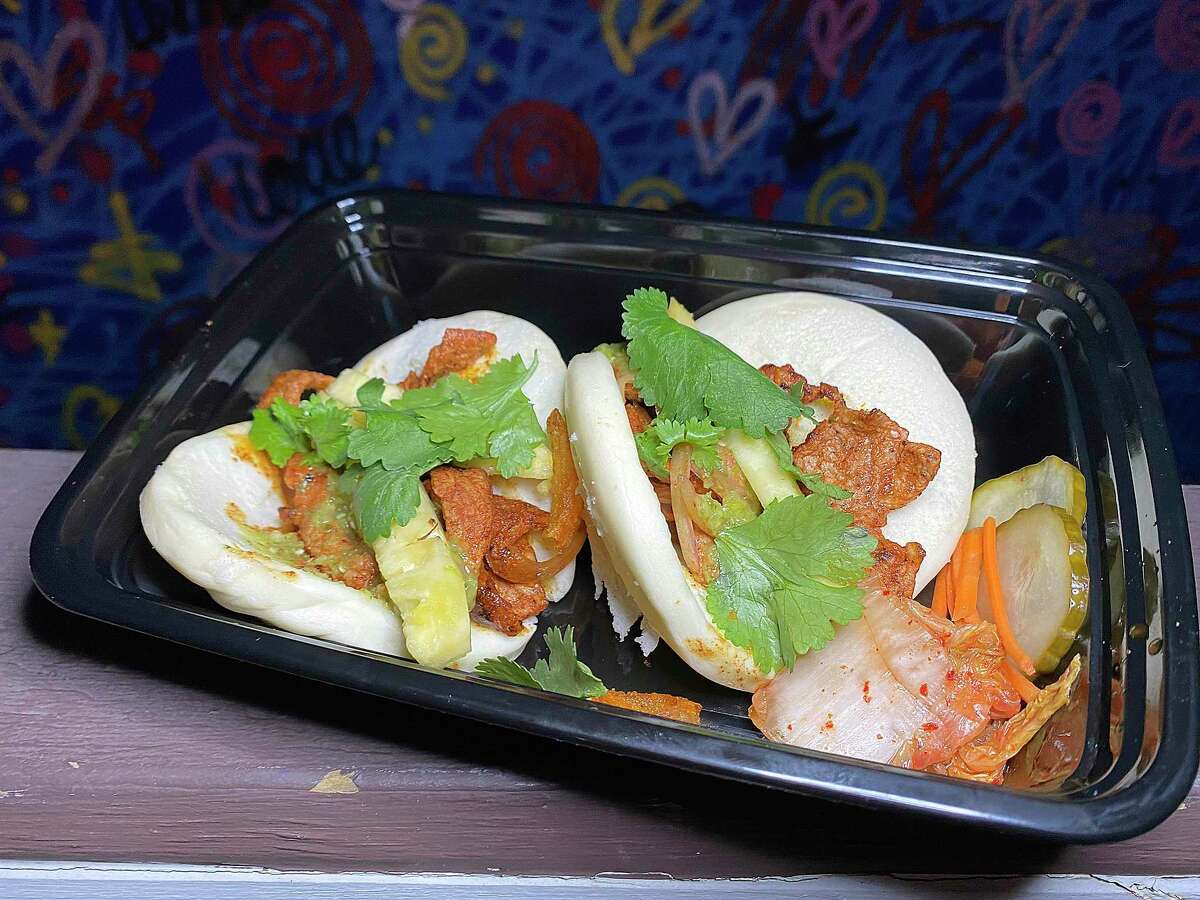 Steamed buns incorporate pork al pastor and pineapple at Mai-O-Mai, a food trailer specializing in Asian-Mexican fusion cooking.