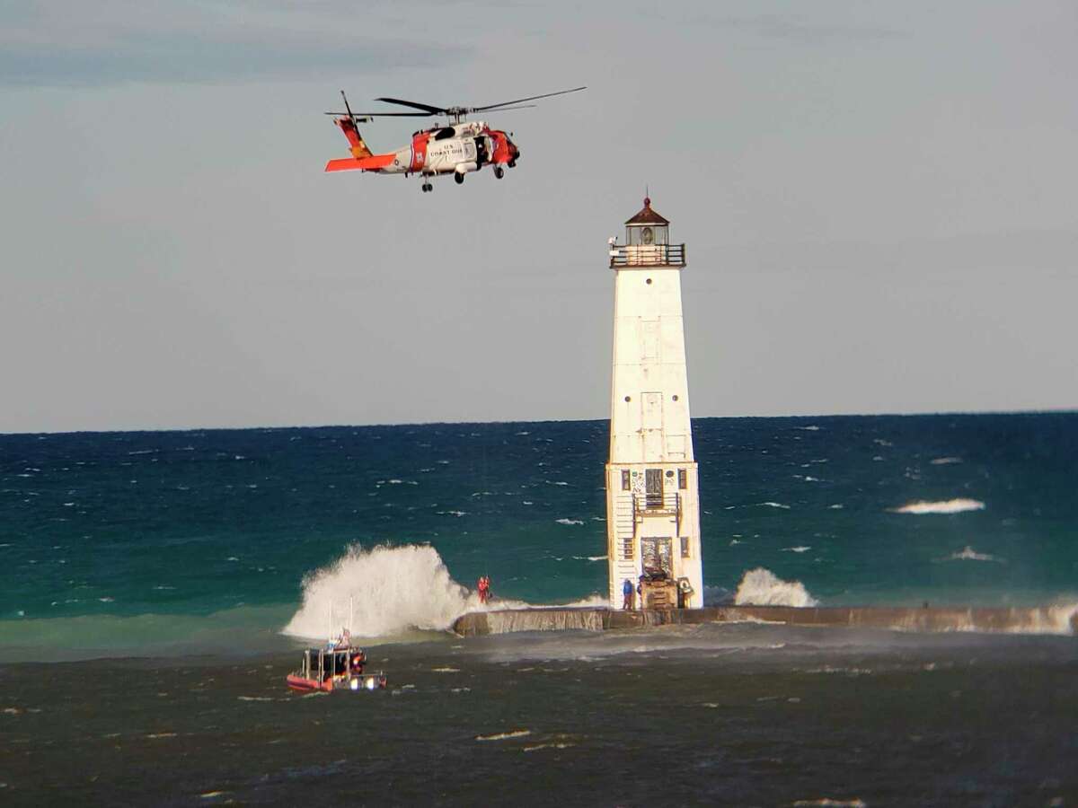 Two men were rescued by the U.S. Coast Guard Station Frankfort using a helicopter when they were trapped on the pier at Frankfort by high wind and waves. (Courtesy Photo/Tom Hitchman)