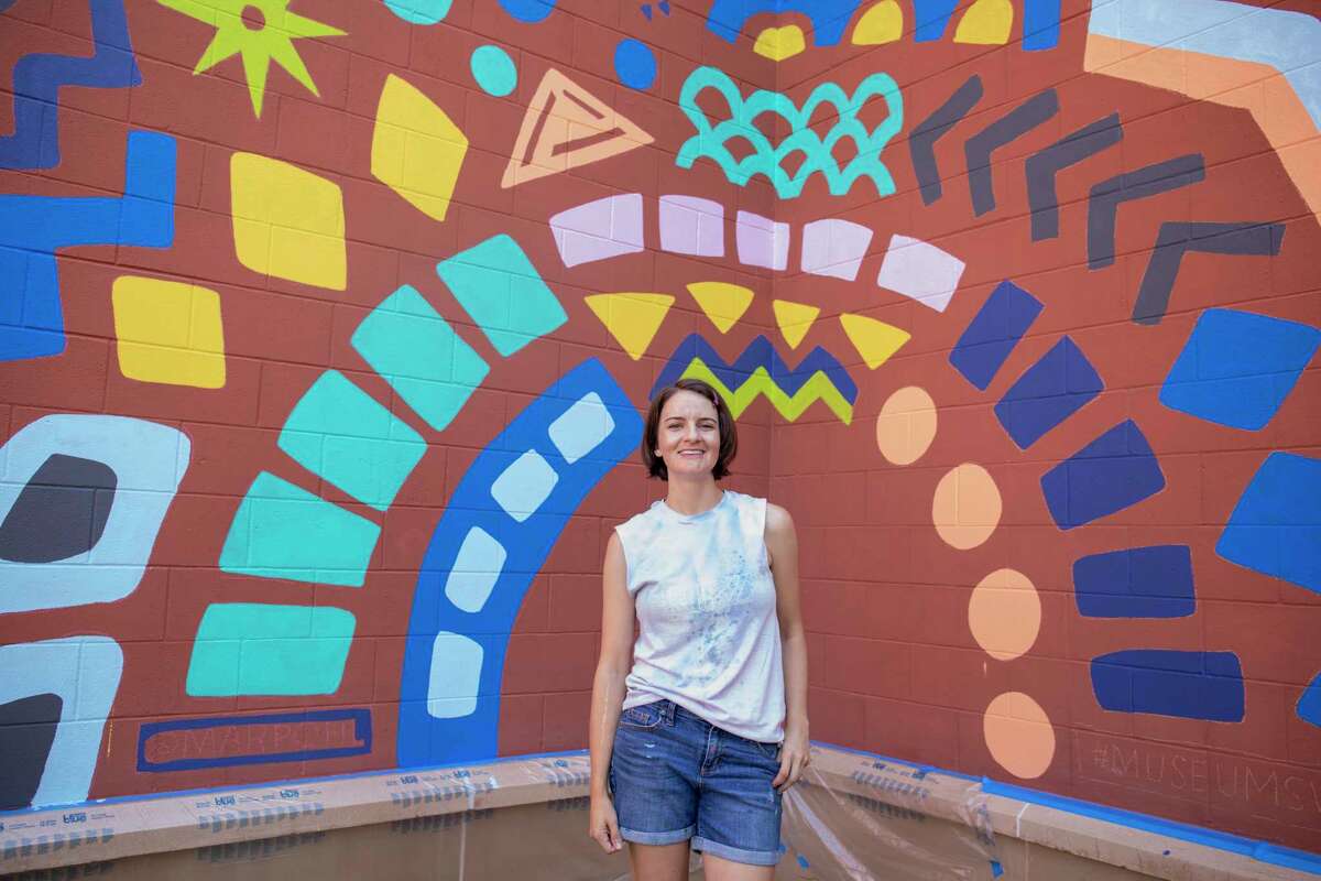 Mari Pohlman poses for a portrait beside a new mural as seen Wednesday, Sept. 8 at the Museum of the Southwest. Pohlman will be painting during the SeptemberFest fundraiser Saturday. She will complete the mural by midday. Jacy Lewis/Reporter-Telegram