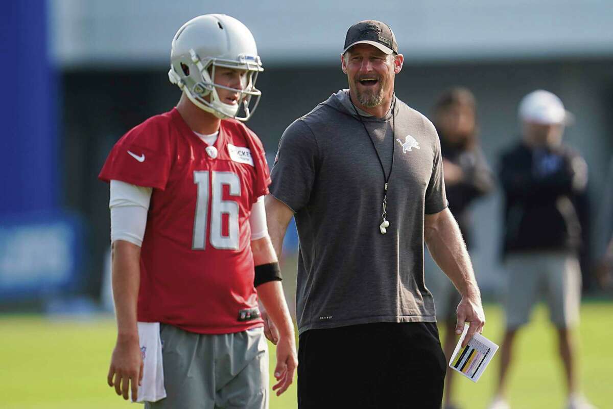 Detroit Lions head coach Dan Campbell talks with quarterback Jared Goff (16) during an NFL football training camp practice in Allen Park, Mich., Saturday, July 31, 2021. (AP Photo/Paul Sancya)