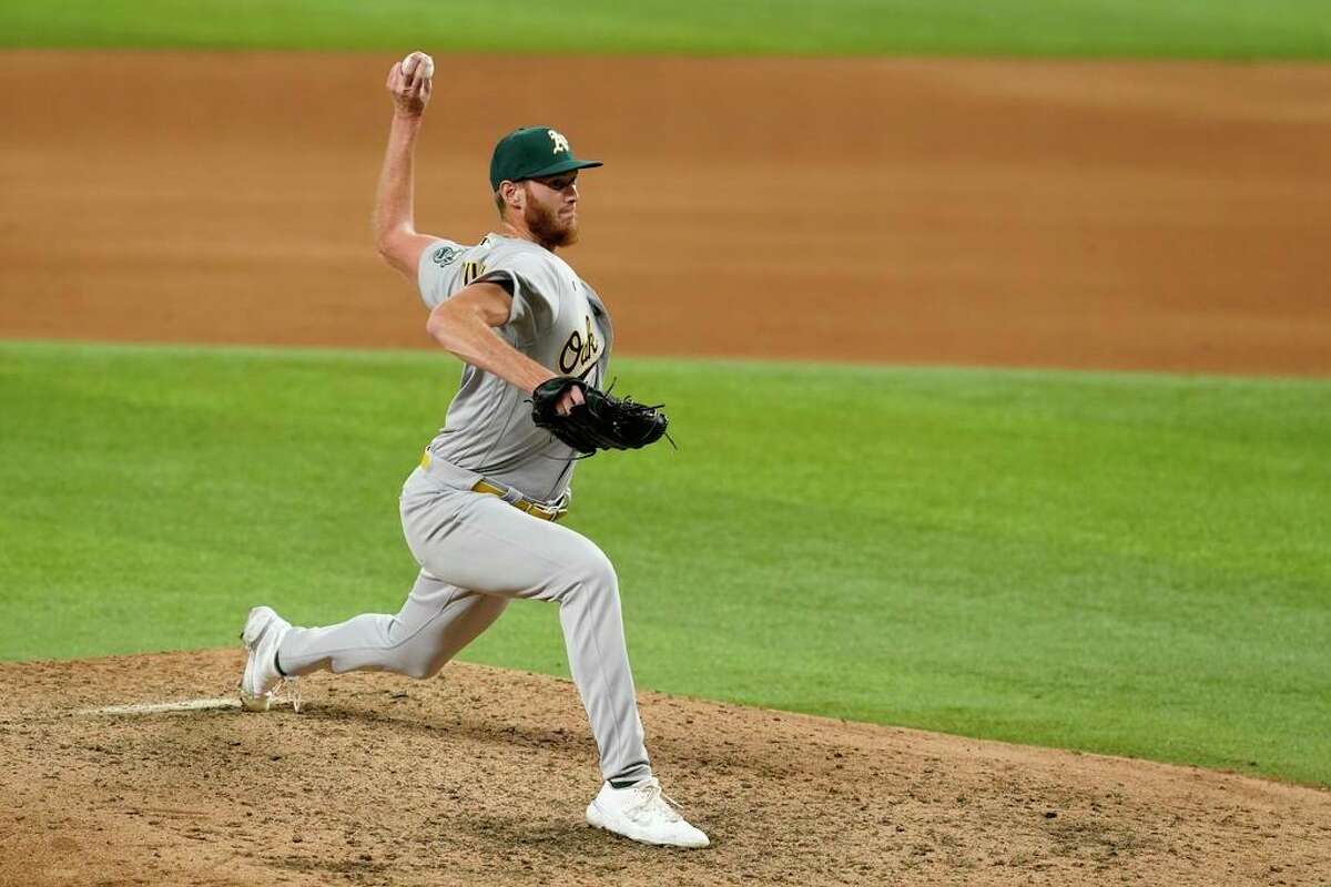 Oakland Athletics relief pitcher A.J. Puk throws in a baseball game against the Texas Rangers in Arlington, Texas, Saturday, Aug. 14, 2021. (AP Photo/Tony Gutierrez)