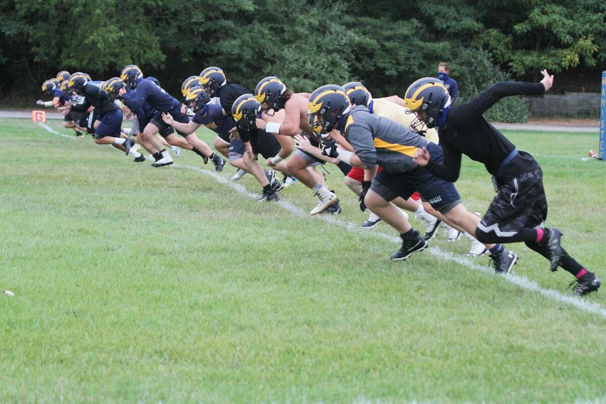 The Manistee football team runs drills on the first day of practice after the Michigan High School Athletic Association reinstated the sport for a fall season. 