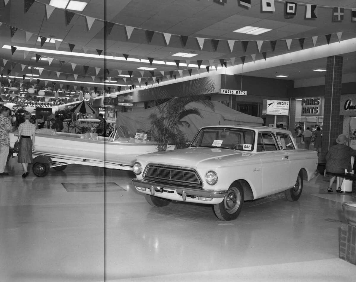 In this 1962 photo, a Rambler American two-door sedan and a boat sit on display in Wonderland Shopping City.