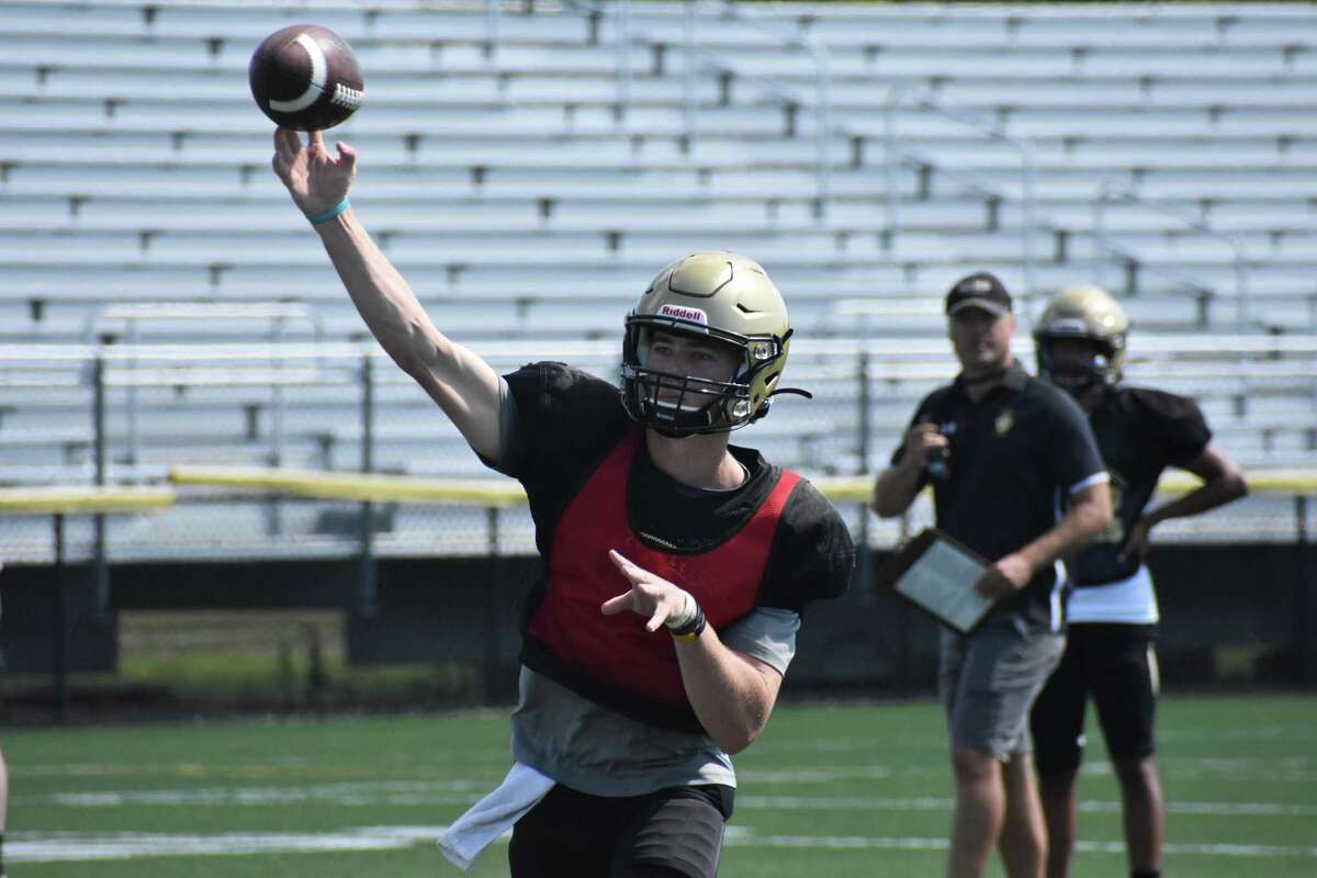 Hand quarterback Patch Flanagan throws against Greenwich during a joint practice in August.
