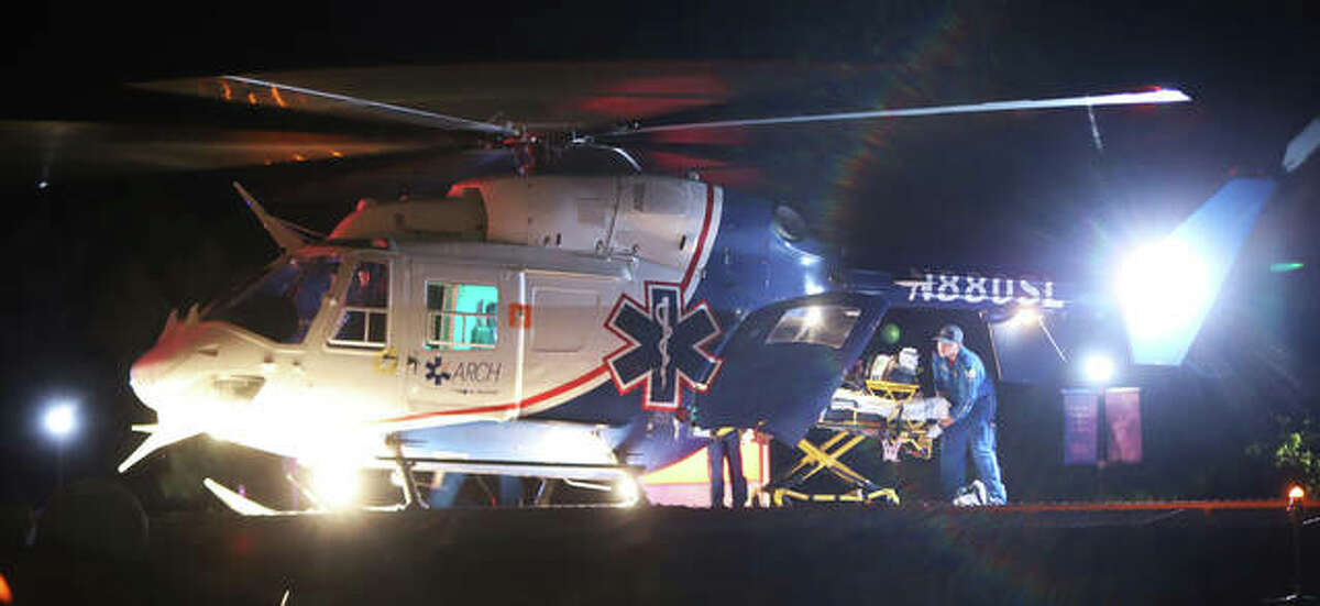 An ARCH Air Medical Services, Inc., helicopter ambulance unloads equipment on the landing pad late Wednesday night at Alton Memorial Hospital to pick up one of three people injured by gunfire on 700 Oakwood Avenue in Alton shortly after 11 p.m. Two additional helicopters also landed at St. Anthony’s Medical Center in Alton for shooting victims.