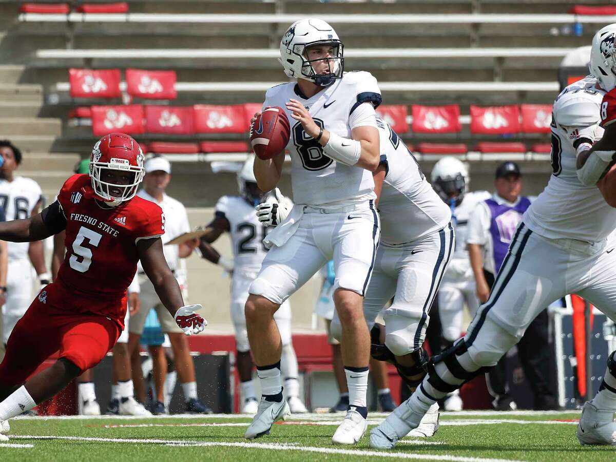 Connecticut quaterback Steven Krajewski looks for a receiver during the second half of the team's NCAA college football game against Fresno State in Fresno, Calif., Saturday, Aug. 28, 2021.