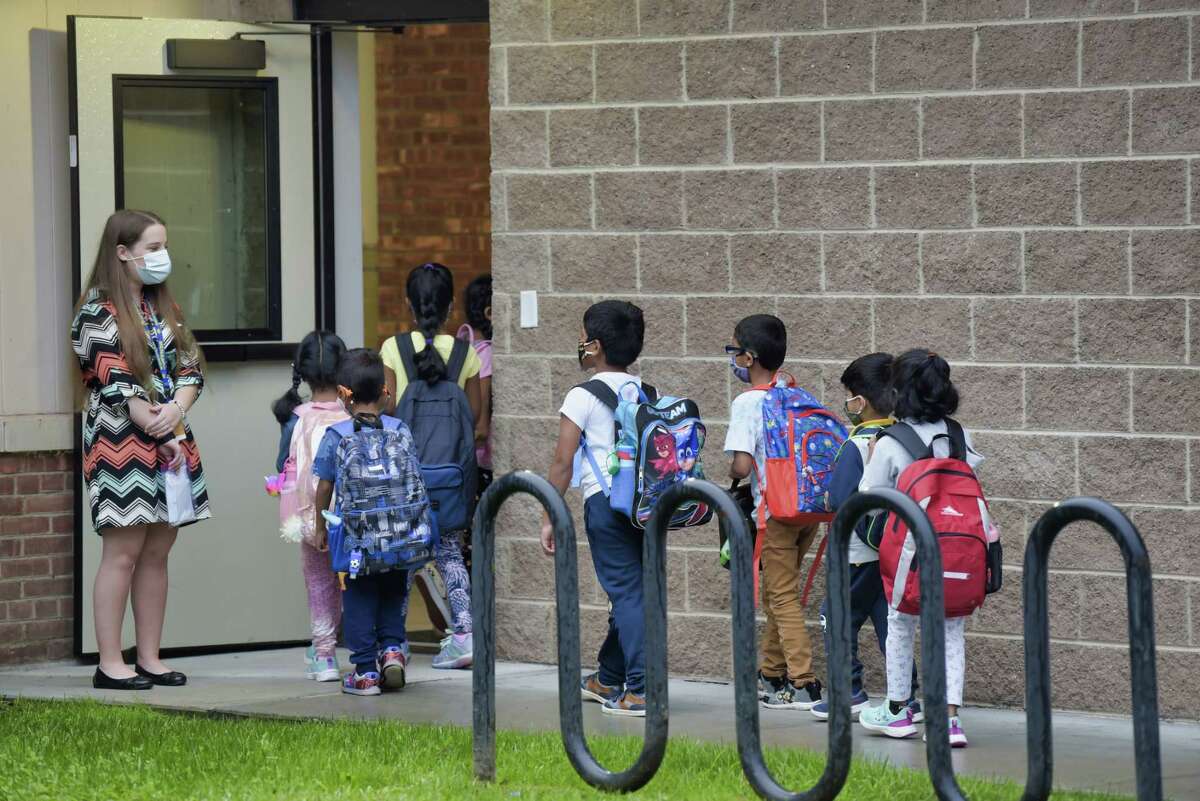 Students make their way into Menands School on the first day of classes on Thursday, Sept. 9, 2021, in Menands, N.Y.