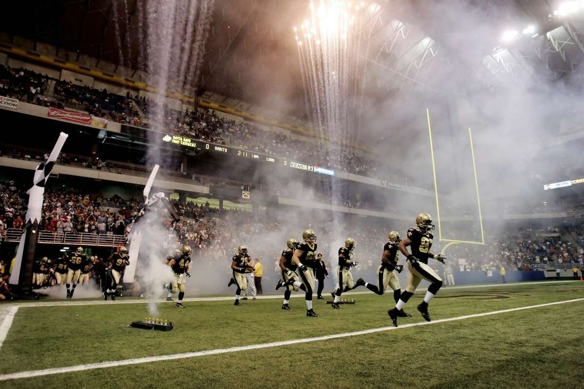 New Orleans Saints players run onto the field at the Alamodome for an NFL game against the Detroit Lions in San Antonio on Dec. 24, 2005. The Lions won 13-12. The Saints played three games in San Antonio following Hurricane Katrina.