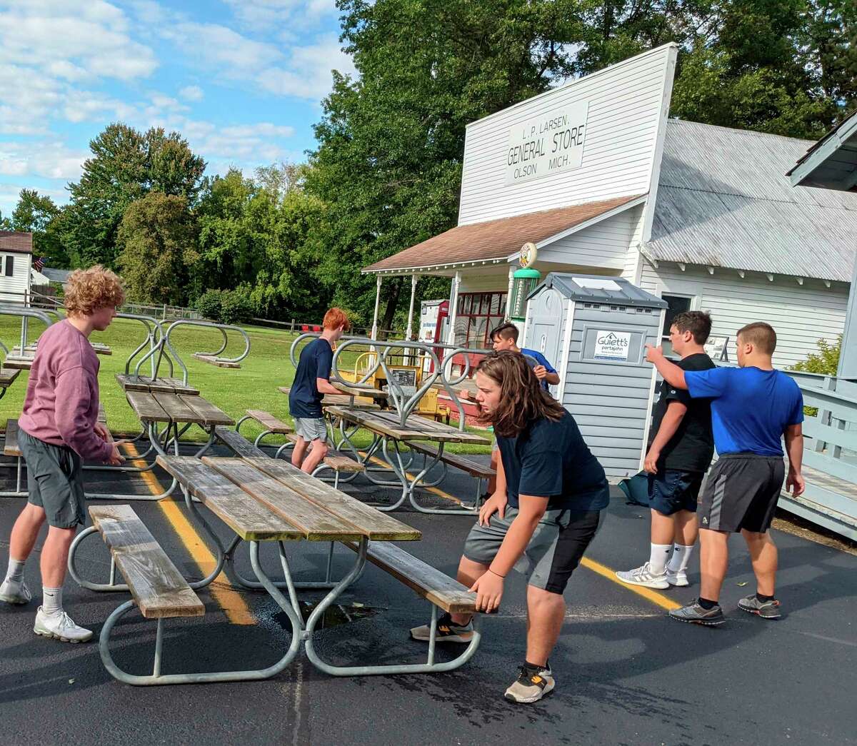 Meridian Early College High School football players help set up for the annual Sanford Founders Day on Wednesday. (Tereasa Nims/for the Daily News)