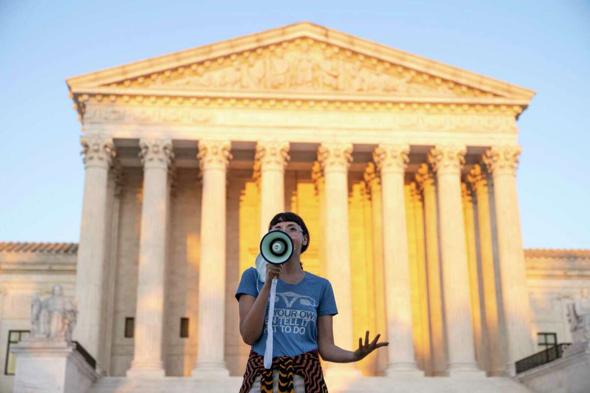 WASHINGTON, DC - SEPTEMBER 02: An activist, who declined to provide her name, speaks outside the Supreme Court in protest against the new Texas abortion law that prohibits the procedure around six weeks into a pregnancy on September 2, 2021 in Washington, DC. The Supreme Court declined to block the law and will let the legal battle play out in the lower courts. (Photo by Drew Angerer/Getty Images)