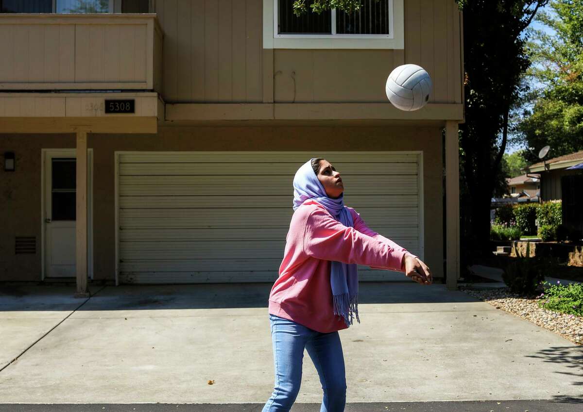 Ghazal Saeedi, 15, practices volleyball in the street outside her home in Sacramento. Though she was born four years after the events of Sept. 11, 2001, they have shaped her life in ways big and small. Because of the work her father did with the U.S. government following the invasion of Afghanistan, her family received special visas to move to California in October 2016, weeks before the election of a U.S. president who appealed to the fatigue over the wars in Afghanistan and Iraq and the fear of immigrants.