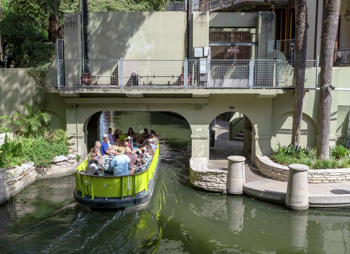 A barge leaves the "cutoff channel" Sept. 3, 2021, as it enters the original San Antonio River channel. The cutoff channel was built following the devastating September 1921 flood that devastated downtown San Antonio to protect businesses from future flooding. To keep the original channel from flooding a large gate lowers from the arch over the river separating the original river channel from the flood control system.