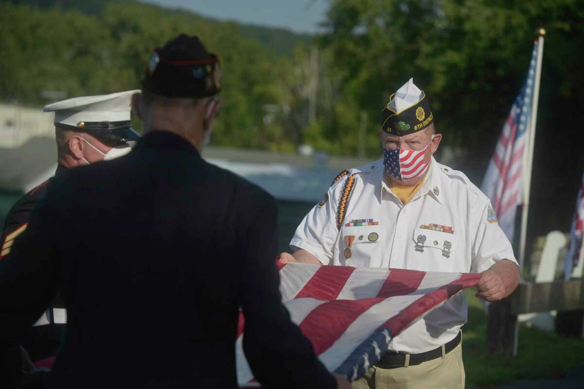 Jeffrey McBreairty, right, American Legion Commander Post 31, folds the flag with assistance from Jim Delancy, VFW Commander New Milford Post 1672, during the memorial ceremony to mark the 19th anniversary of September 11, 2001. Friday, September 11, 2020, in New Milford, Conn.