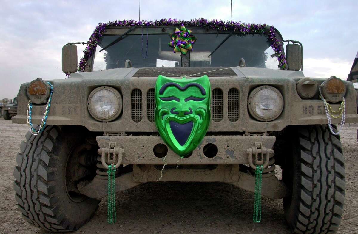 A Humvee from Louisiana's 256th Brigade is decorated as a float for a Mardi Gras parade at Camp Liberty in Baghdad, Iraq on Sunday, Feb. 6, 2005. The National Guard soldiers celebrated Mardi Gras two days early so that the maximum number of soldiers could participate. The parade was followed by a meal of chicken and sausage gumbo, red beans and rice and King cake. (AP Photo/Chris Tomlinson) Ran on: 02-07-2005 Ran on: 02-07-2005
