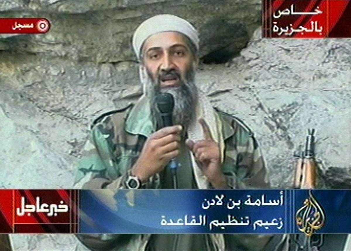 Osama bin Laden is seen at an undisclosed location in this television image broadcast in this Oct. 7, 2001 file photo. Bin Laden praised God for the Sept. 11 terrorist attacks and swore America "will never dream of security" until "the infidel's armies leave the land of Muhammad," in a videotaped statement aired after the strike launched Sunday by the U.S. and Britain in Afghanistan. Graphic at top right reads "Exclusive to Al-Jazeera." At bottom right is the station's logo which reads "Al-Jazeera." At top left is "Recorded." Bottom left is "Urgent news." At bottom center is "Osama bin Laden, Leader of the al-Qaida." (AP Photo/Al Jazeera, File)