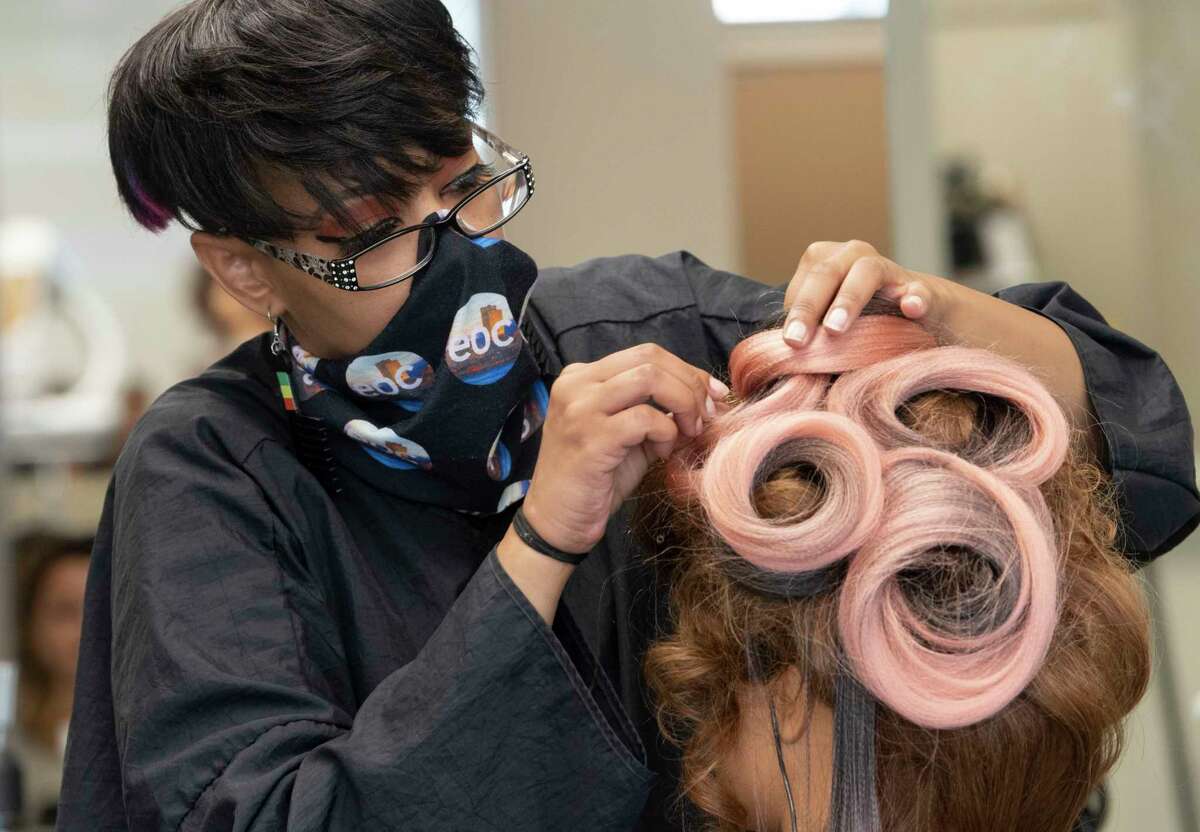 Student Gabrielle Harris works on the hair of a mannequin for an avant-garde project in the cosmetology classroom at the Capital District Educational Opportunity Center on Thursday, Sept. 9, 2021 in Troy, N.Y.