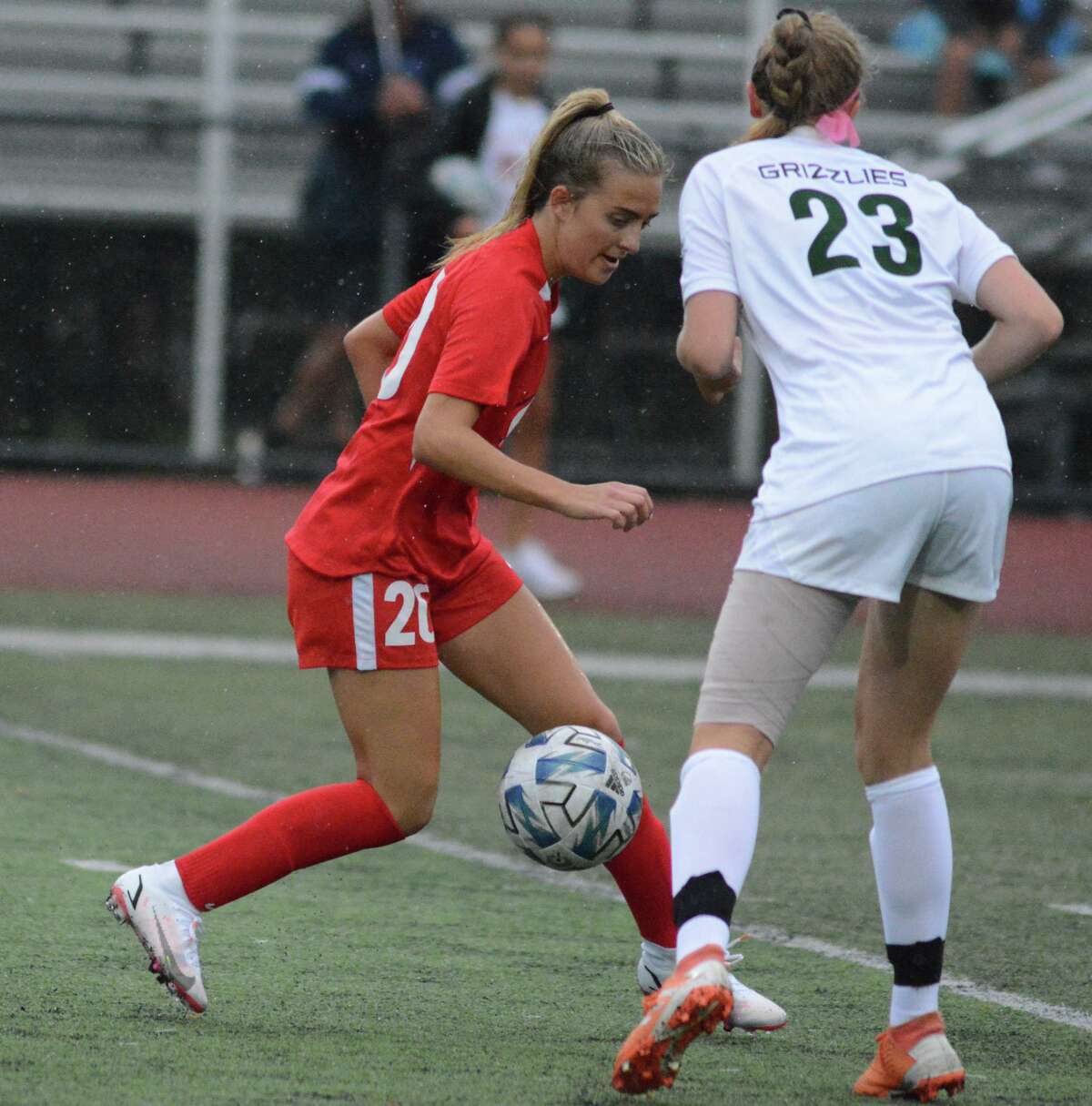 Ariana Geloso of Cheshire controls the ball as she goes past Abby Moore of Guilford on Thursday.
