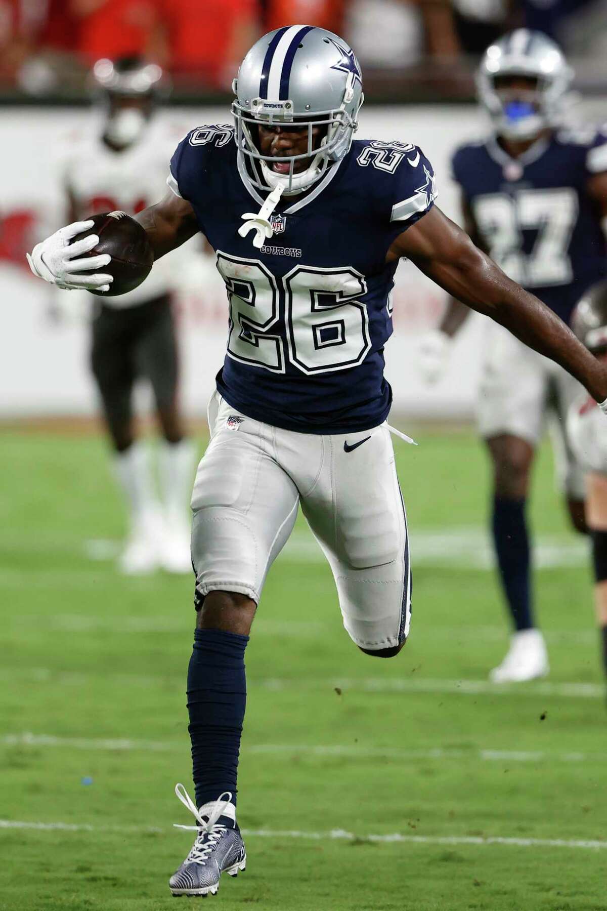 Dallas Cowboys cornerback Jourdan Lewis runs with the football after intercepting a pass by Tampa Bay Buccaneers quarterback Tom Brady during the first half of an NFL football game Thursday, Sept. 9, 2021, in Tampa, Fla.
