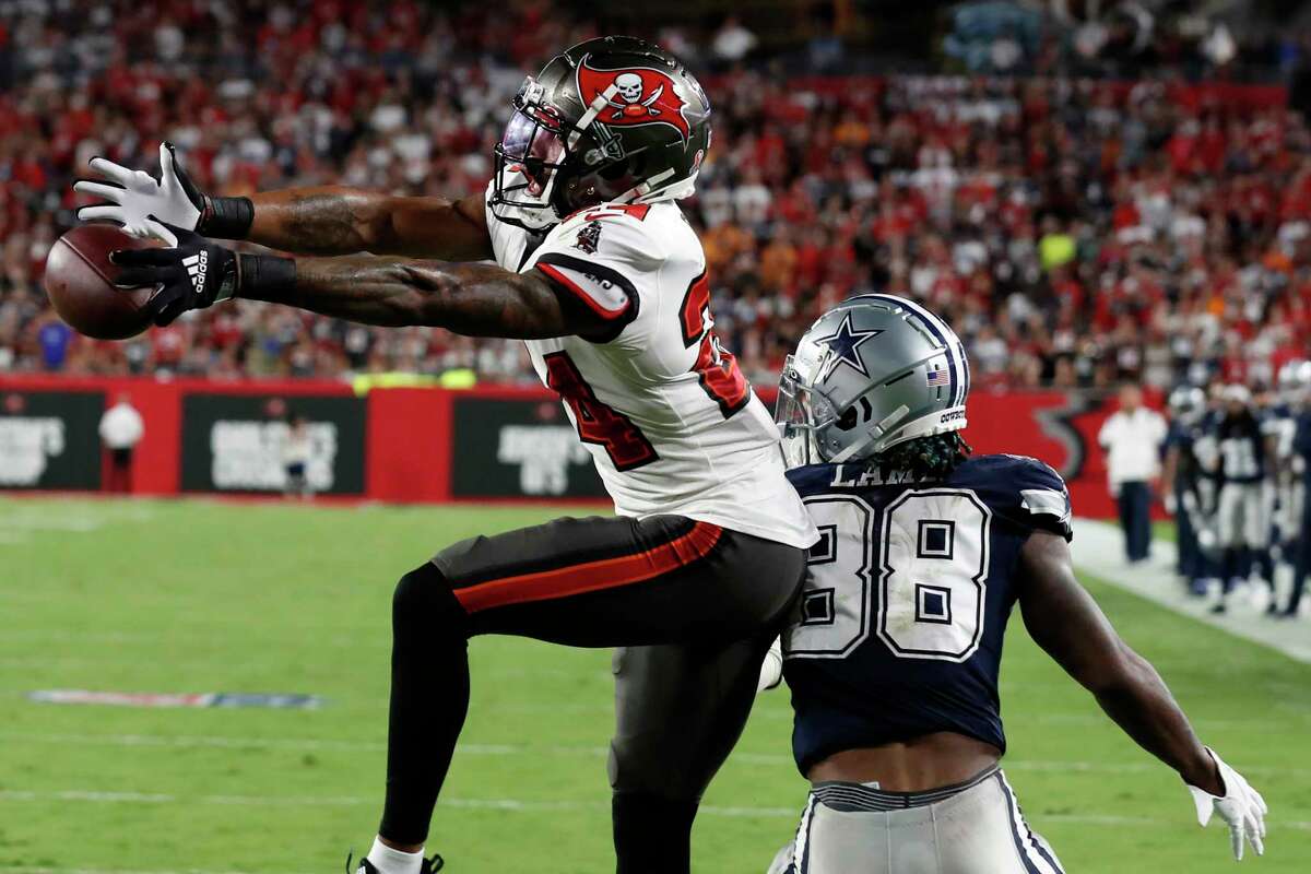 Tampa Bay Buccaneers cornerback Carlton Davis III (24) breaks up a pass intended for Dallas Cowboys wide receiver CeeDee Lamb (88) during the second half of an NFL football game Thursday, Sept. 9, 2021, in Tampa, Fla.