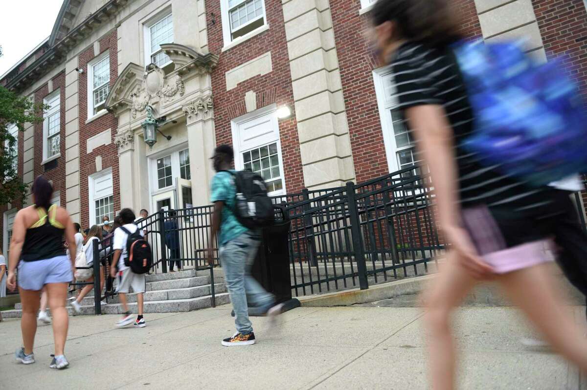 Students enter the first day of school at Stamford High School in Stamford, Conn. Monday, Aug. 30, 2021.
