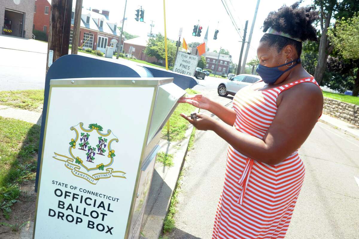 Aurelia William-Philpotts, of Stratford, drops her absentee ballot for last year’s primary elections into a state ballot drop box outside of Stratford Town Hall, in Stratford, Conn. Aug. 10, 2020.