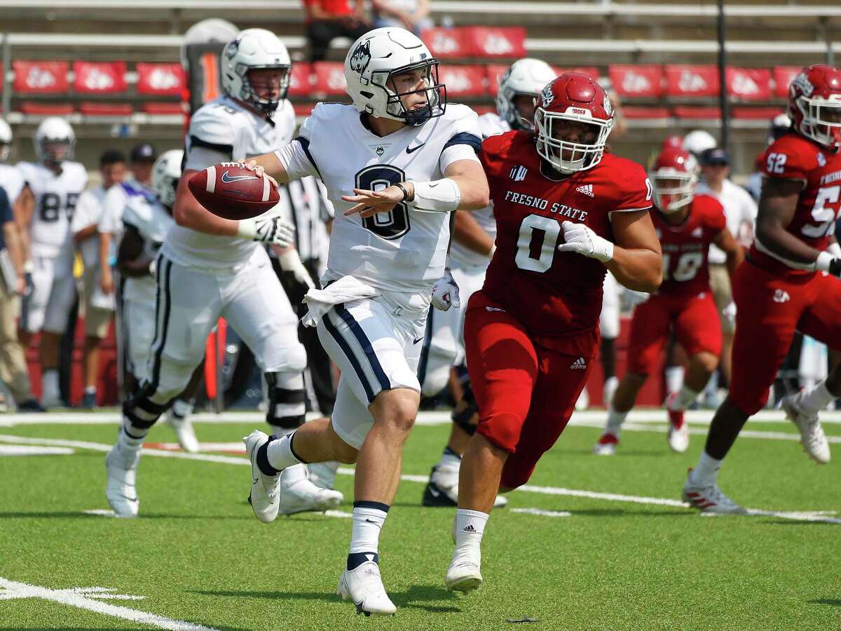 Connecticut quaterback Steven Krajewski rolls out to pass against Fresno State during the second half of an NCAA college football game in Fresno, Calif., Saturday, Aug. 28, 2021. (AP Photo/Gary Kazanjian)