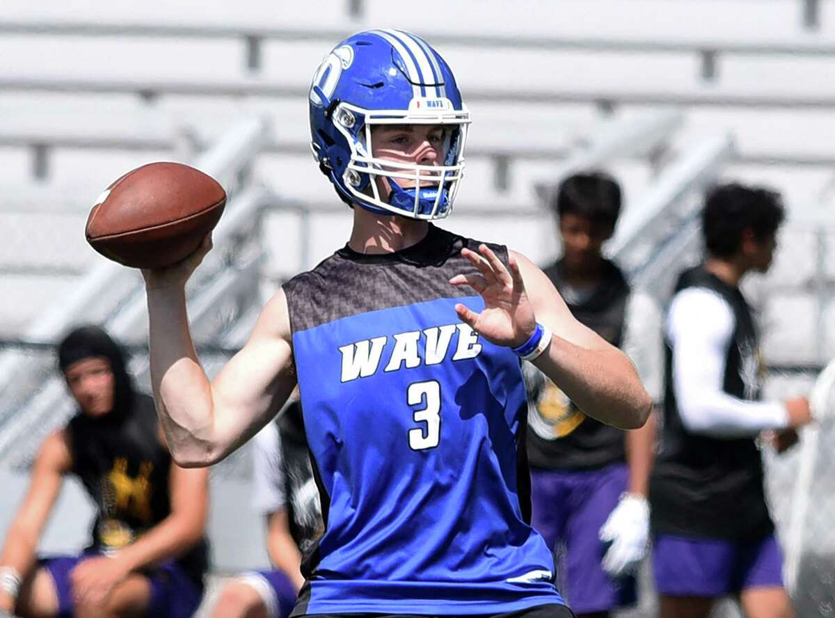 Darien's Miles Drake gets set to throw a pass on day one of the Grip It and Rip It football tournament in New Canaan on Friday, July 9, 2021.