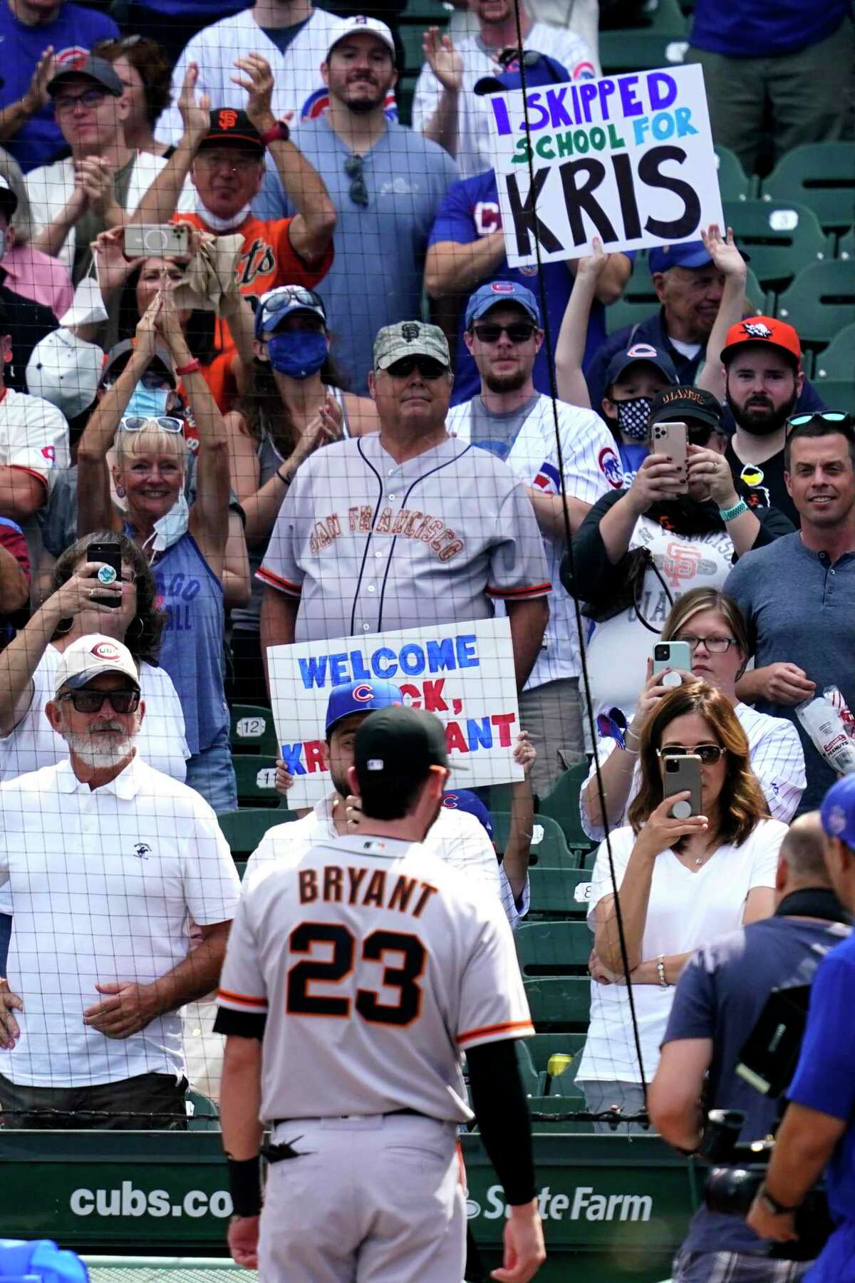 Chicago Cubs fans greet San Francisco Giants' Kris Bryant (23) before a baseball game in Chicago, Friday, Sept. 10, 2021. (AP Photo/Nam Y. Huh)